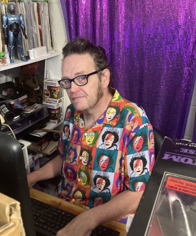 Ian Bell seated as a computer